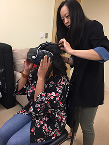 Woman putting on VR headset with help from another woman